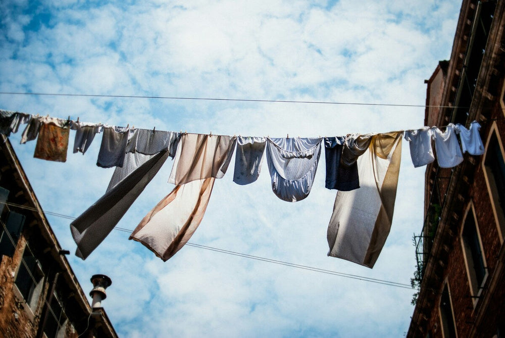 Sleepwear and bed linen hanging up to dry, from worm's eye view