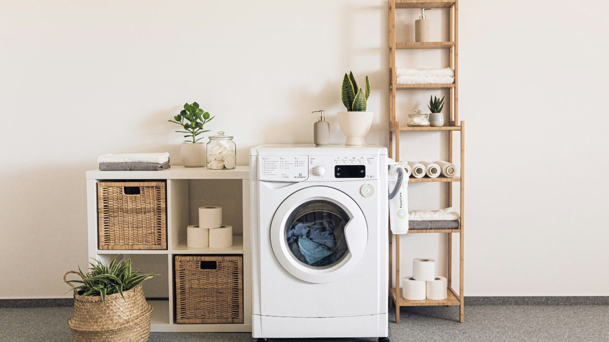 Washing machine in a beige coloured washroom next to wicker baskets full of laundry and a shelf